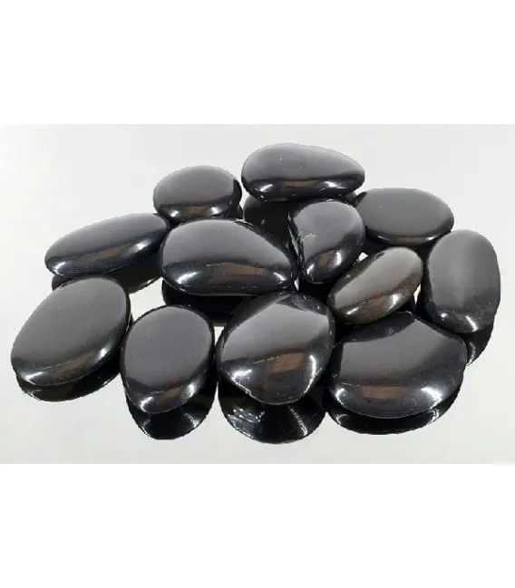 Group of polished oval black agate energy stones on a reflective white surface.