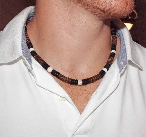 Handmade Men's Queen Conch and Coconut Shell spiritual necklace for protection and abundance, worn by a model in a clean white polo shirt, showing bead detail and fit.