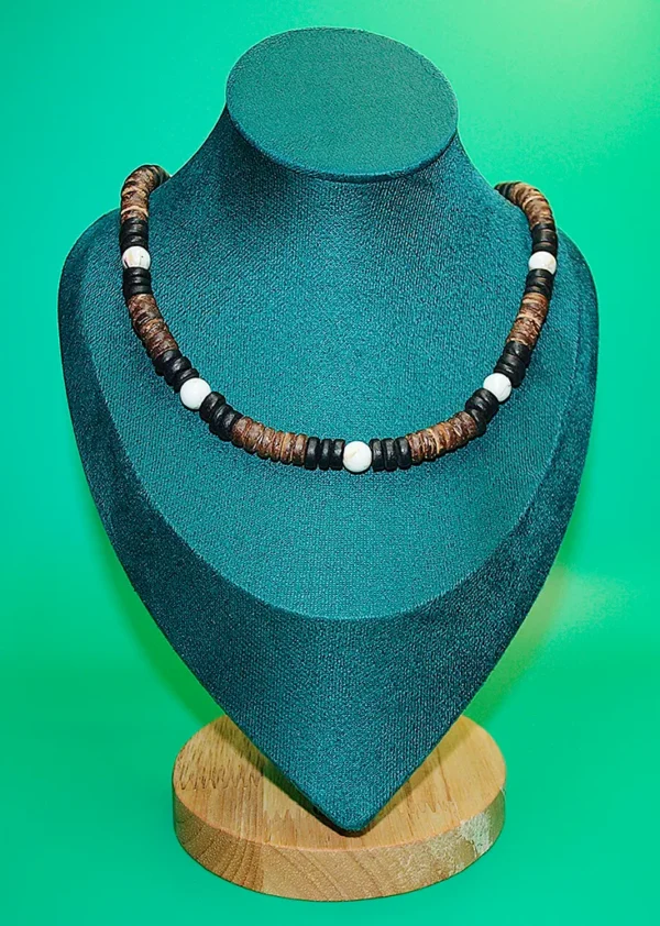 Handcrafted Queen Conch and coconut shell beaded necklace showcased on a teal jewelry mannequin bust with a wood base.
