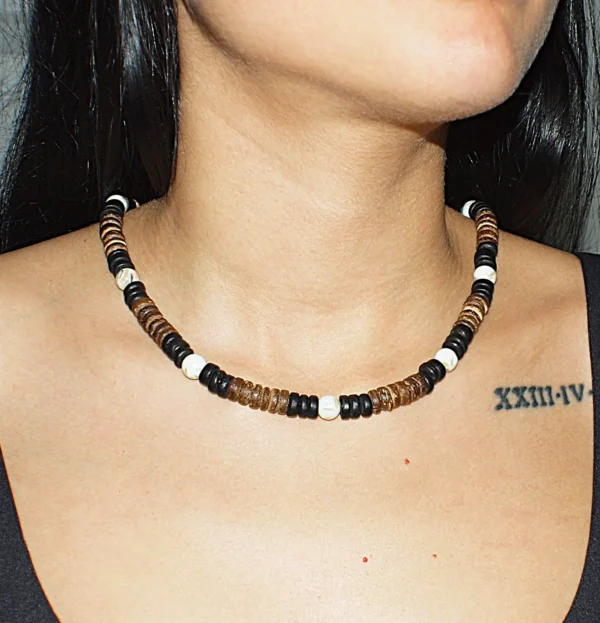 Woman wearing a handmade Queen Conch and Coconut Shell necklace featuring natural black, white and brown shell beads by GUACA-inc