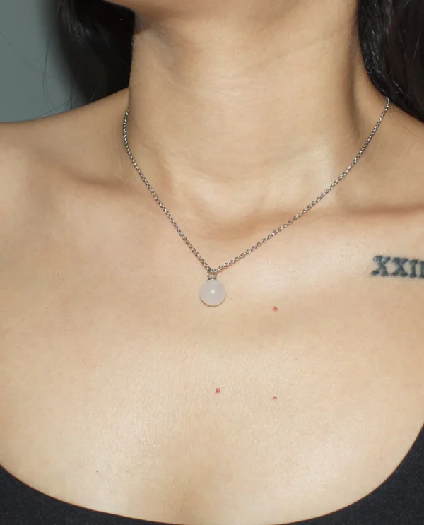 Natural Rose Quartz sphere pendant necklace for heart chakra healing and emotional balance.