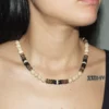 Close-up of a woman wearing a handcrafted Trochus shell and coconut shell beaded necklace.